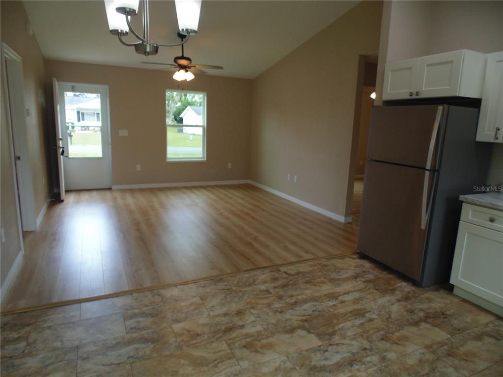 10856 Southwest 79th Avenue Ocala, FL 34476 - Photo 6 of 33 an empty room with wooden floor cabinet and windows