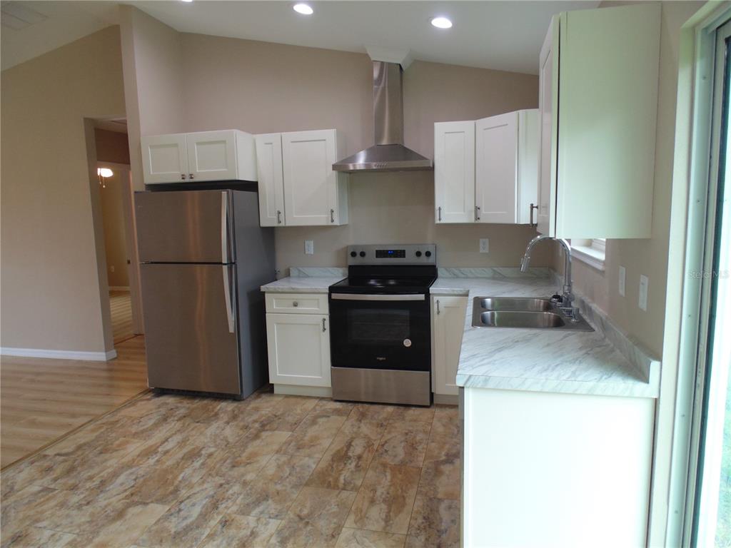 10856 Southwest 79th Avenue Ocala, FL 34476 - Photo 6 of 33 a kitchen with a refrigerator sink and stove