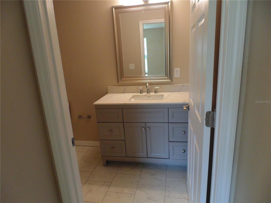 10856 Southwest 79th Avenue Ocala, FL 34476 - Photo 10 of 33 a bathroom with a sink and a mirror