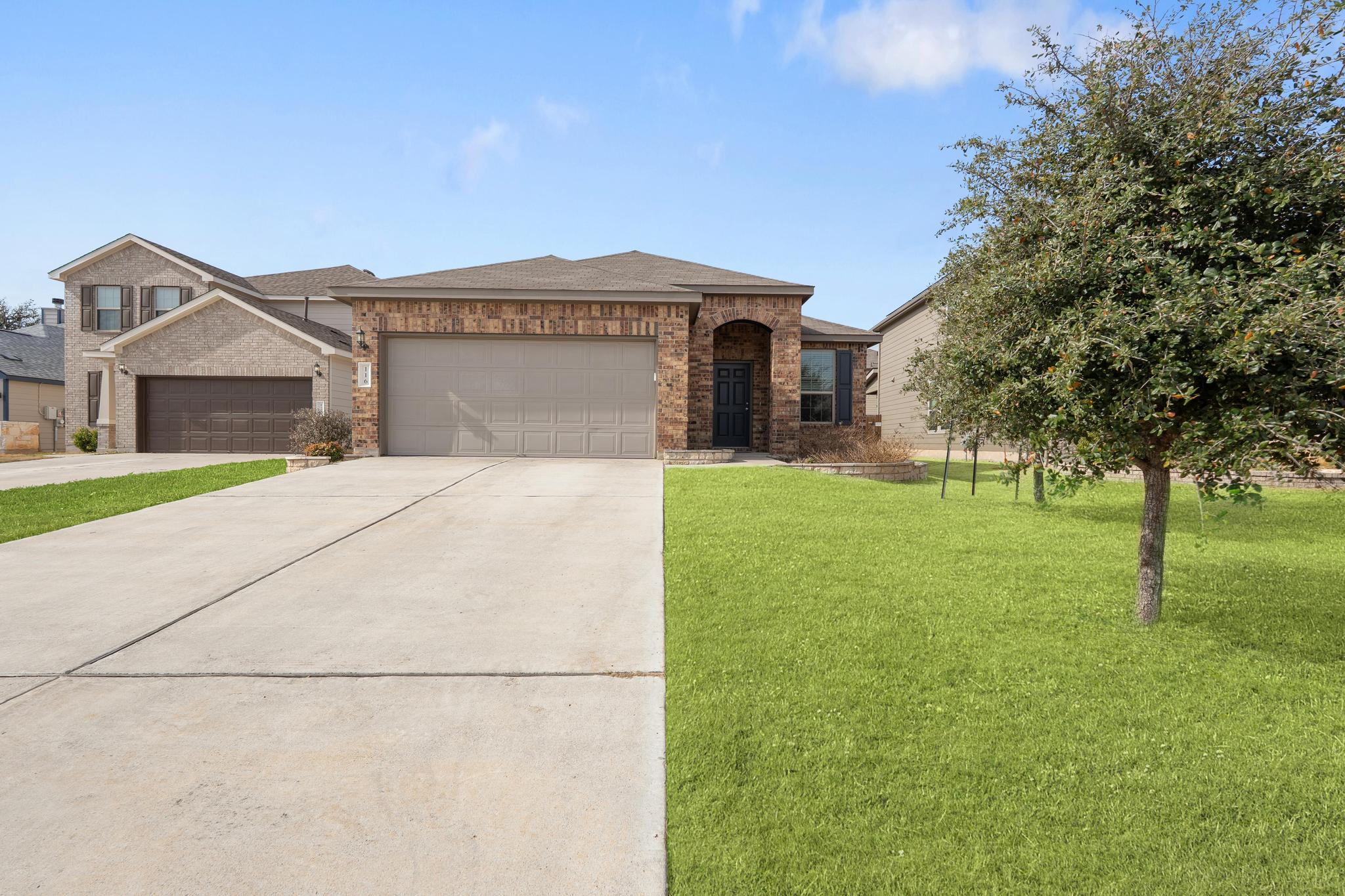 a front view of a house with a yard and garage