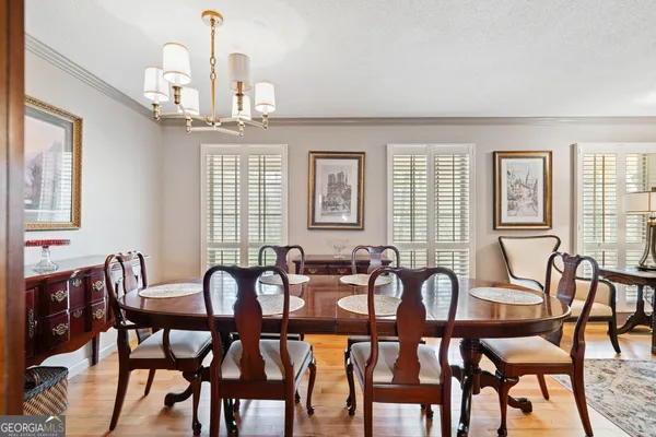 a view of a a dining room with furniture window and wooden floor