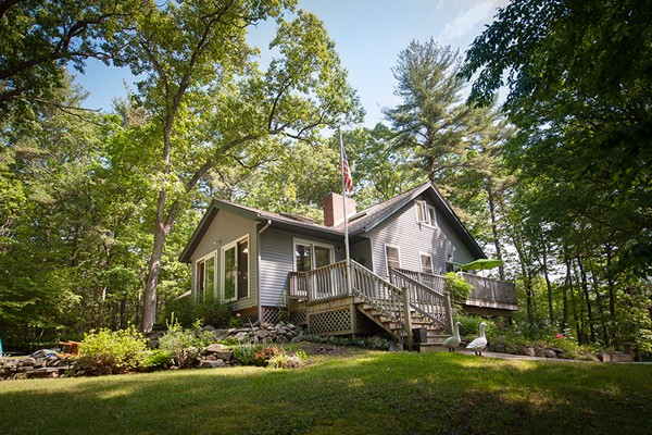 a front view of house with yard and green space