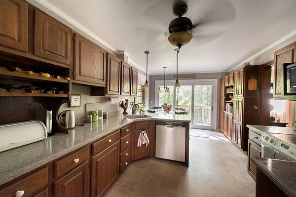 31 Chapman Road Boxford, MA 01921 - Photo 7 of 27 a kitchen with stainless steel appliances granite countertop a sink a stove and a refrigerator