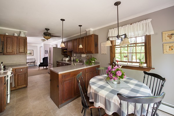 31 Chapman Road Boxford, MA 01921 - Photo 8 of 27 a kitchen that has a lot of cabinets chairs and appliances