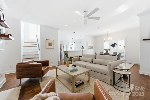 a living room with furniture a ceiling fan and a window