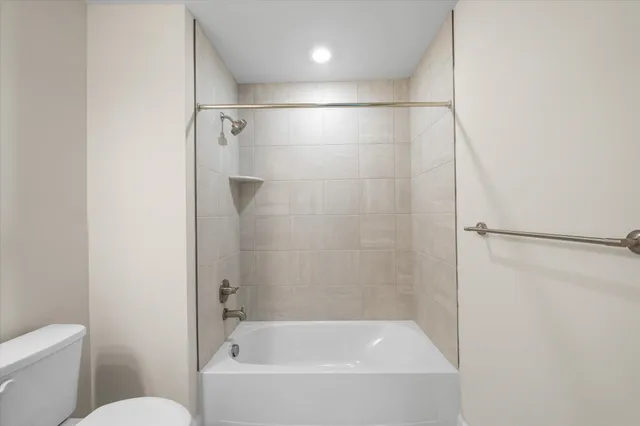 a bathroom with a bathtub and a toilet