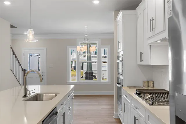 a kitchen with granite countertop a sink a counter top space and cabinets