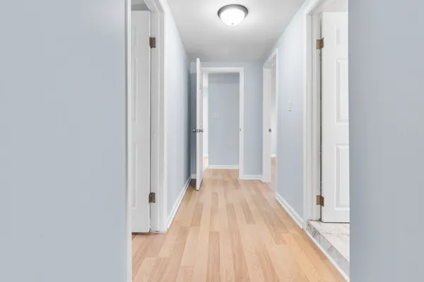 a view of a room with wooden floor