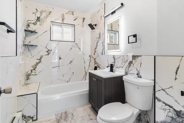 a bathroom with a sink toilet and bathtub