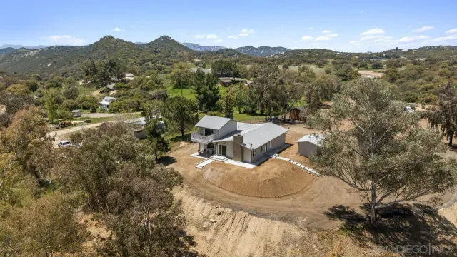 an aerial view of a house with mountain view