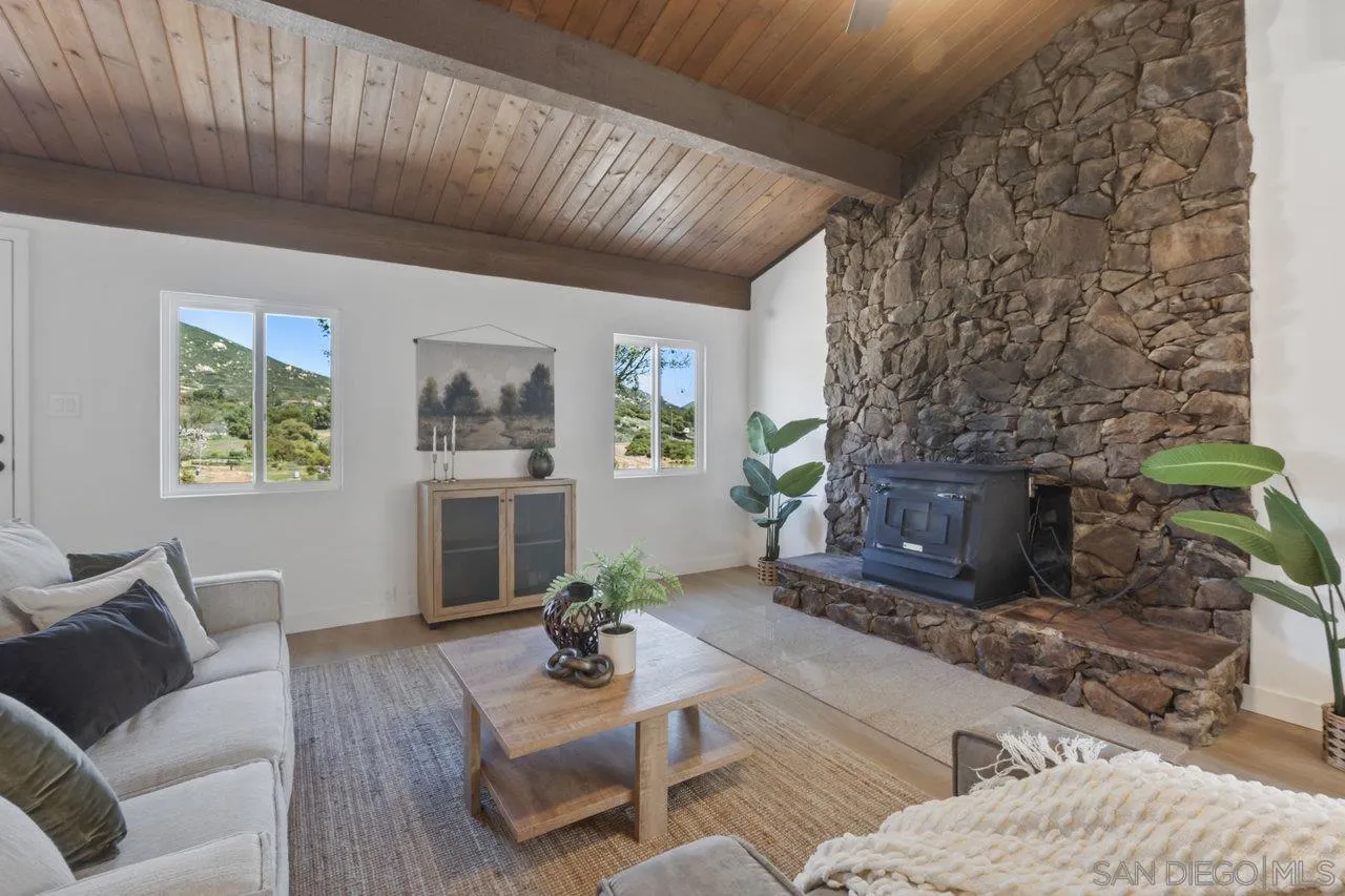 23471 Japatul Valley Road Alpine, CA 91901 - Photo 11 of 57 a living room with furniture and a fireplace