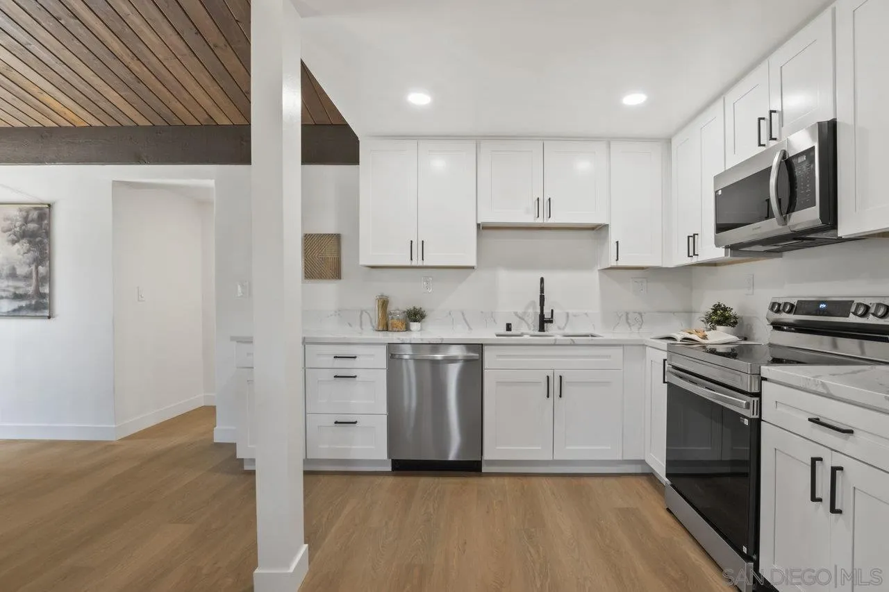 23471 Japatul Valley Road Alpine, CA 91901 - Photo 12 of 57 a kitchen with white cabinets stainless steel appliances and sink