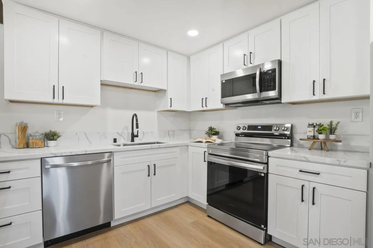 23471 Japatul Valley Road Alpine, CA 91901 - Photo 13 of 57 a kitchen with cabinets stainless steel appliances and sink