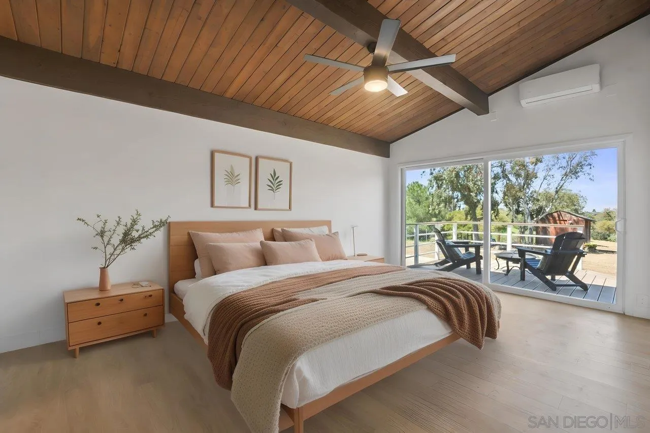 23471 Japatul Valley Road Alpine, CA 91901 - Photo 20 of 57 a bed room with a bed and a large window
