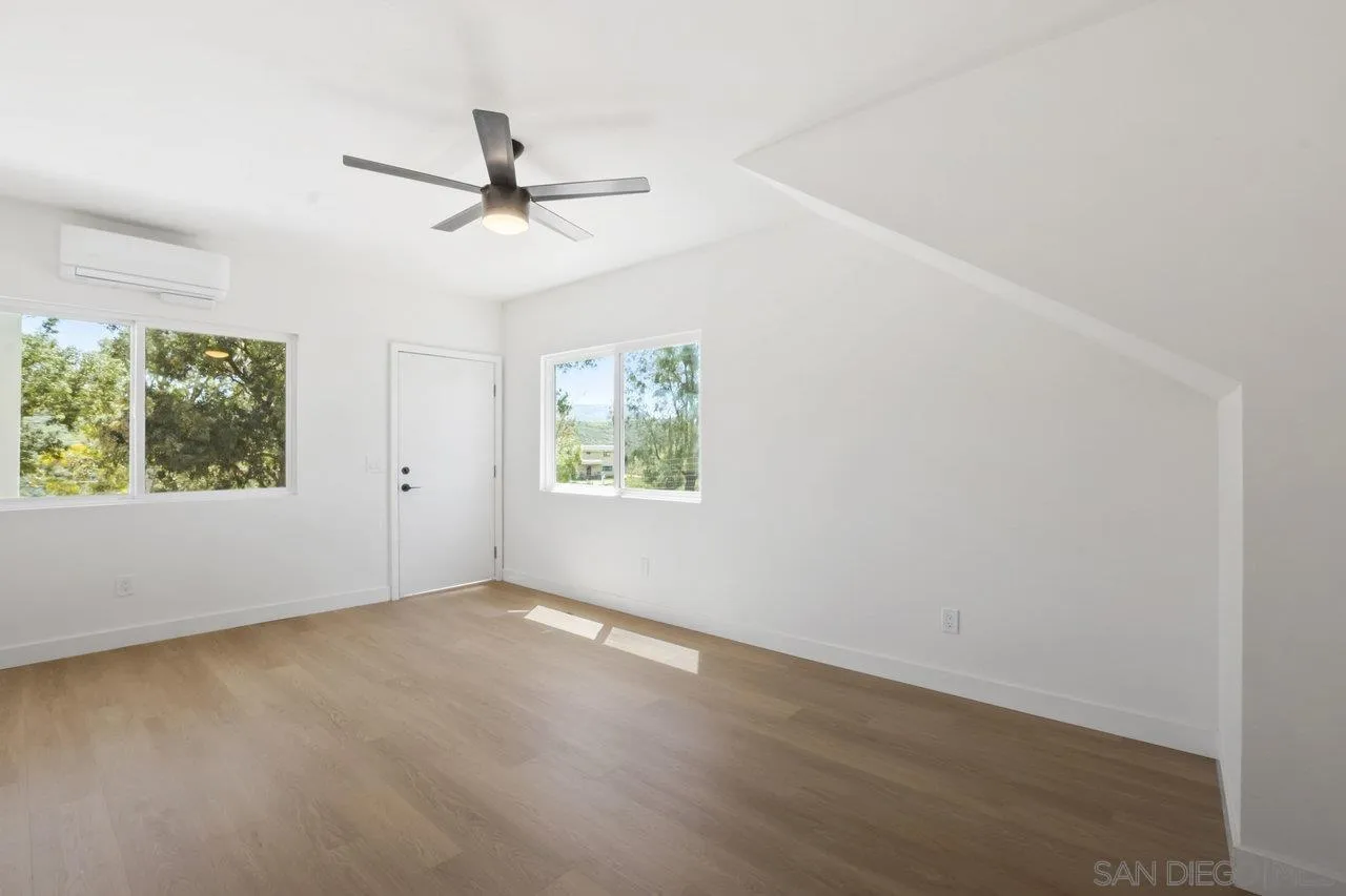 23471 Japatul Valley Road Alpine, CA 91901 - Photo 24 of 57 an empty room with windows and ceiling fan