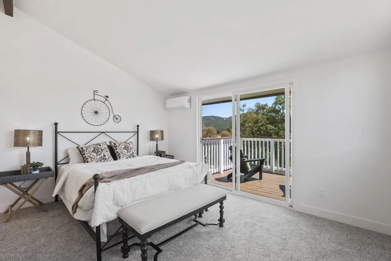 23471 Japatul Valley Road Alpine, CA 91901 - Photo 26 of 57 a bedroom with a bed and a window