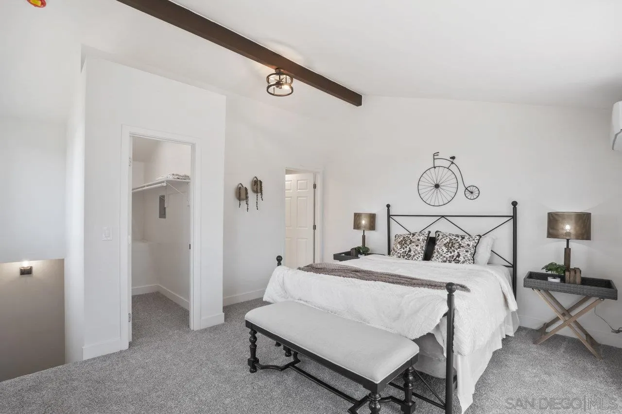23471 Japatul Valley Road Alpine, CA 91901 - Photo 27 of 57 a bedroom with a bed and white cabinets