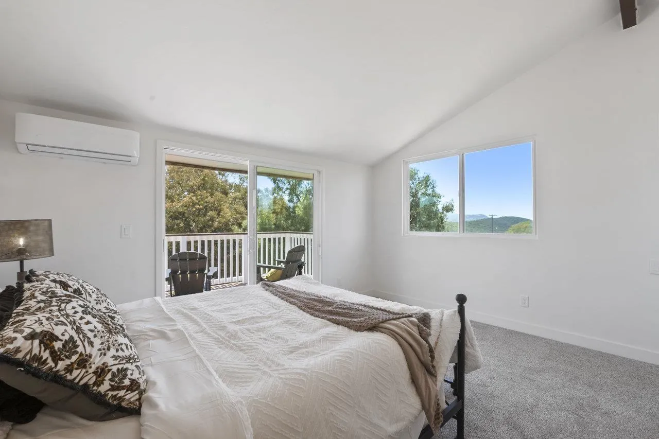 23471 Japatul Valley Road Alpine, CA 91901 - Photo 29 of 57 a bedroom with a bed and a window