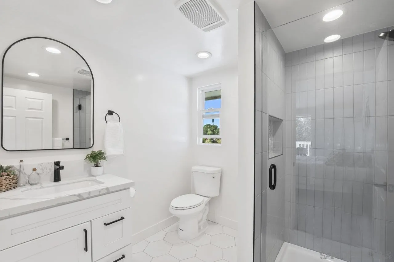 23471 Japatul Valley Road Alpine, CA 91901 - Photo 30 of 57 a bathroom with a granite countertop sink a toilet and a mirror