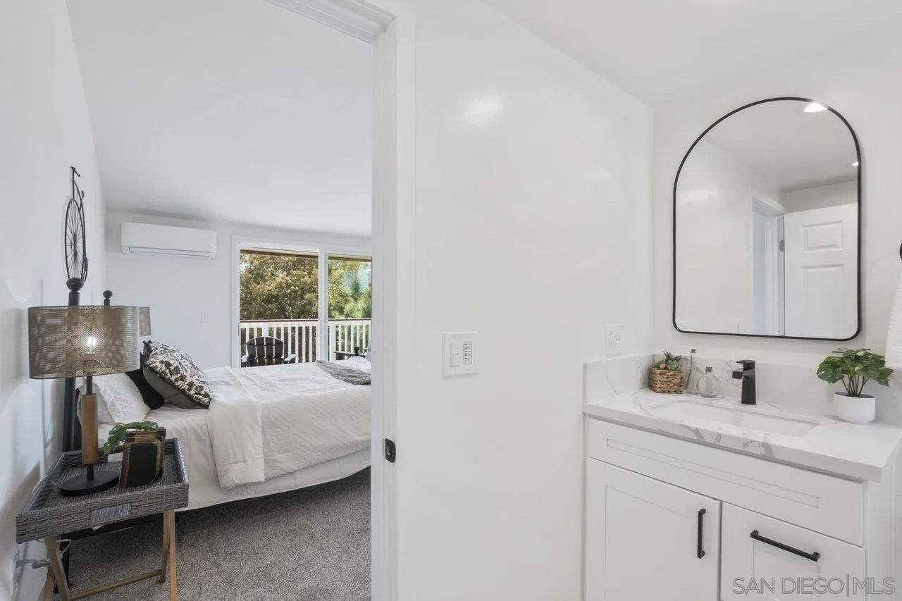 23471 Japatul Valley Road Alpine, CA 91901 - Photo 31 of 57 a bedroom with a bed and a window