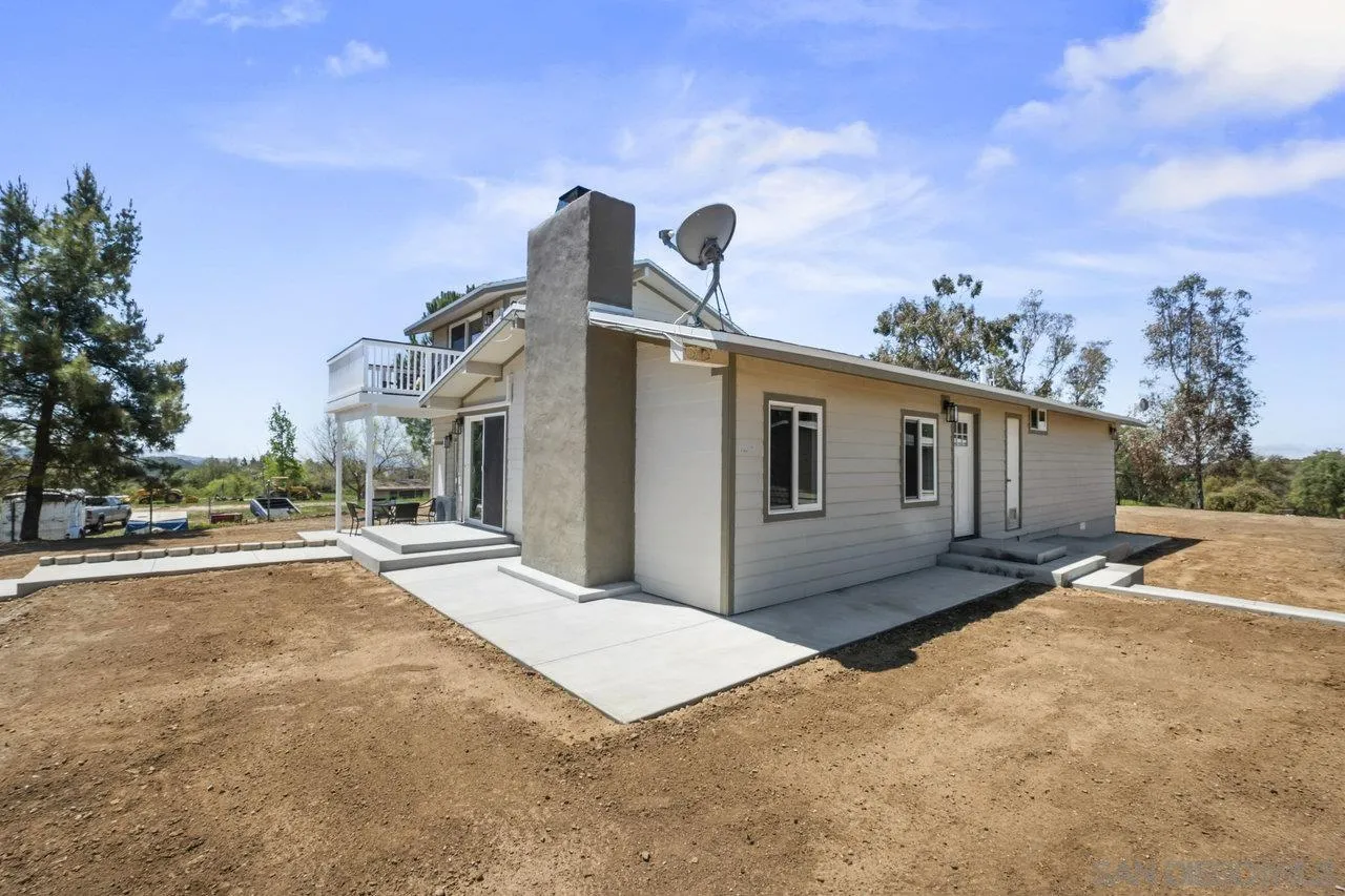 23471 Japatul Valley Road Alpine, CA 91901 - Photo 36 of 57 a front view of a house with a yard and garage