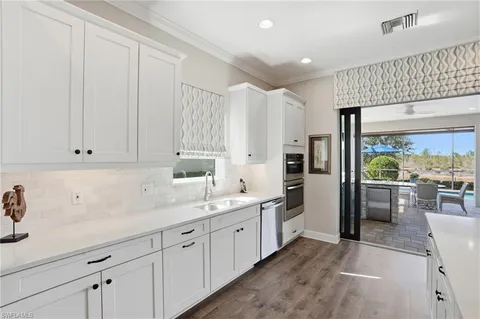 a kitchen with refrigerator and cabinets