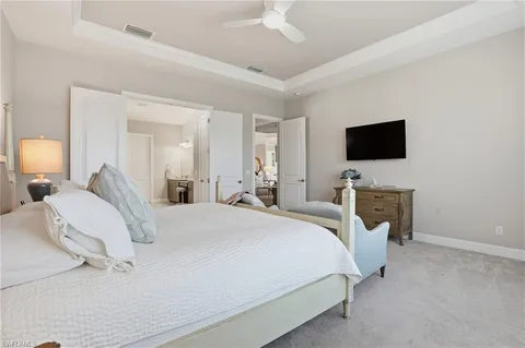 a spacious bedroom with bed and a large window