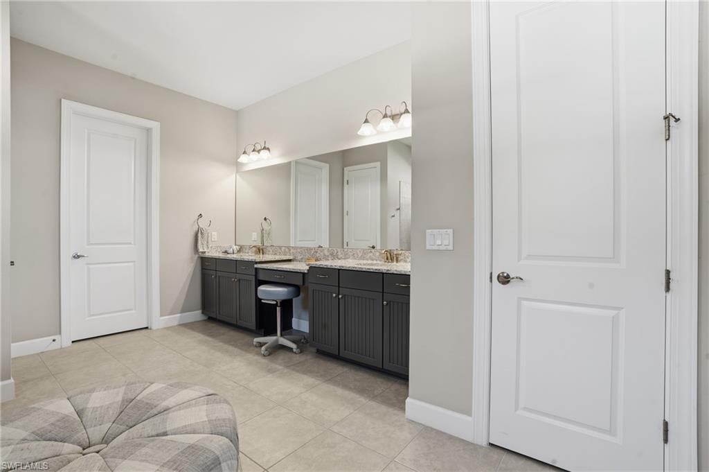 9489 Montelanico Loop Naples, FL 34119 - Photo 21 of 49 Bathroom featuring vanity and light tile patterned floors