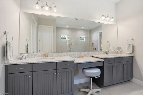 a bathroom with a double vanity sink and a mirror