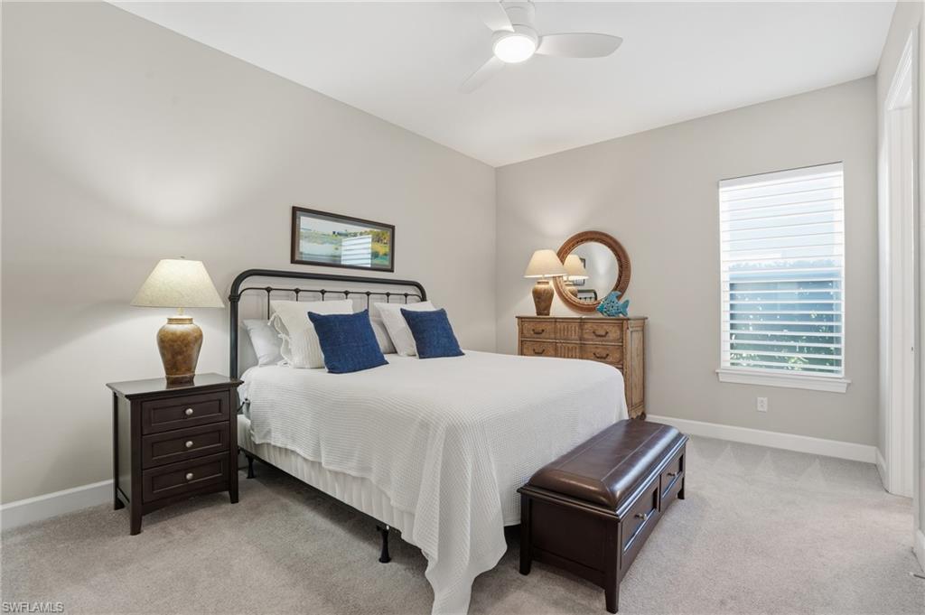 9489 Montelanico Loop Naples, FL 34119 - Photo 26 of 49 Bedroom with light colored carpet and ceiling fan