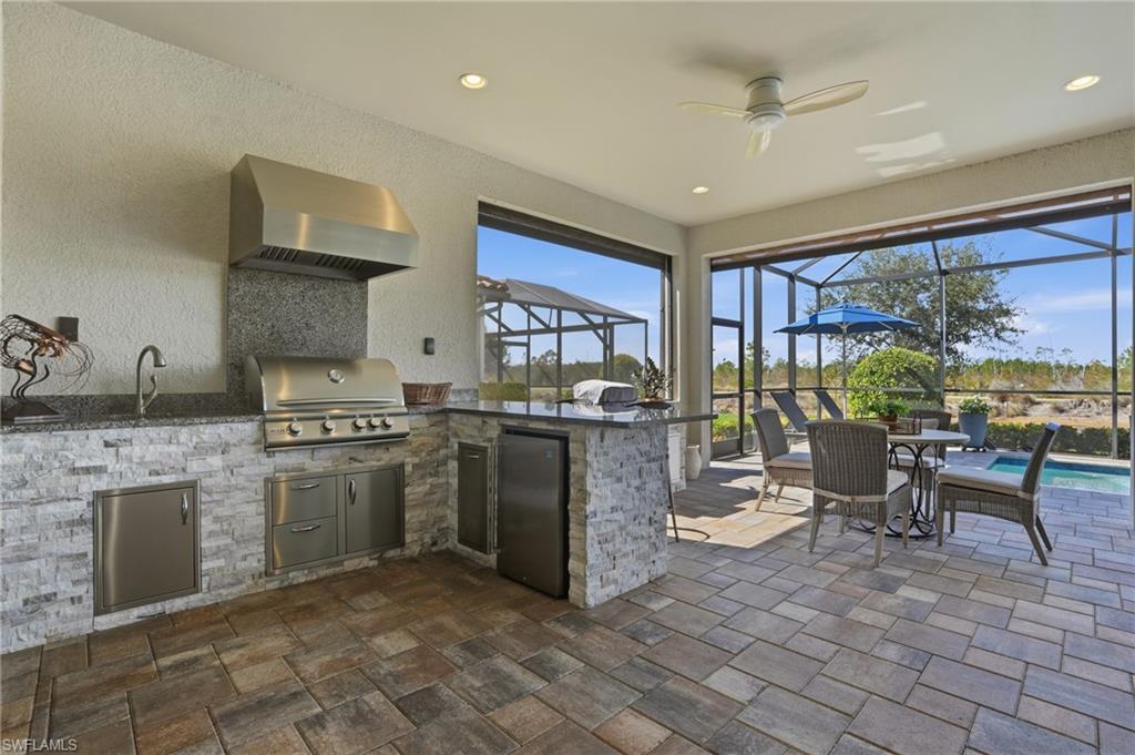 9489 Montelanico Loop Naples, FL 34119 - Photo 31 of 49 View of patio / terrace featuring glass enclosure, a ceiling fan, a sunroom, area for grilling, and an outdoor pool