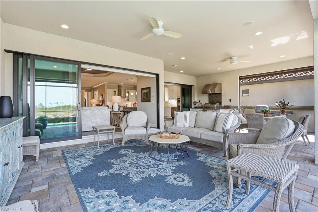 9489 Montelanico Loop Naples, FL 34119 - Photo 33 of 49 Living room with stone tile flooring, ceiling fan, and recessed lighting