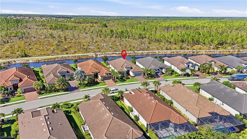 9489 Montelanico Loop Naples, FL 34119 - Photo 4 of 49 Aerial perspective of suburban area featuring a nearby body of water