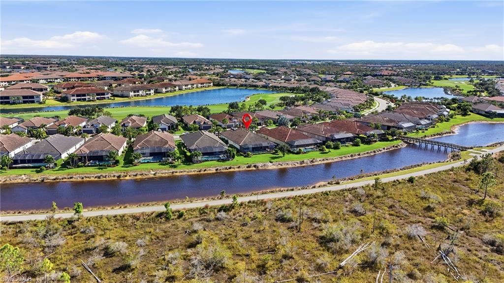 9489 Montelanico Loop Naples, FL 34119 - Photo 39 of 49 Aerial view of residential area featuring a large body of water