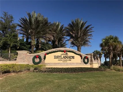 an aerial view of a city with lots of residential buildings ocean and mountain view in back