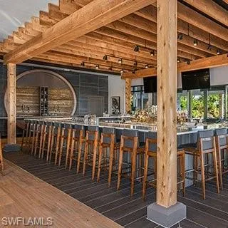 a large kitchen with a table chairs and a wooden floor