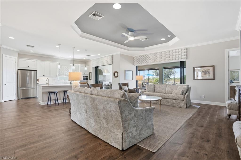 9489 Montelanico Loop Naples, FL 34119 - Photo 6 of 49 Living room featuring crown molding, healthy amount of natural light, dark wood-style floors, a ceiling fan, and recessed lighting