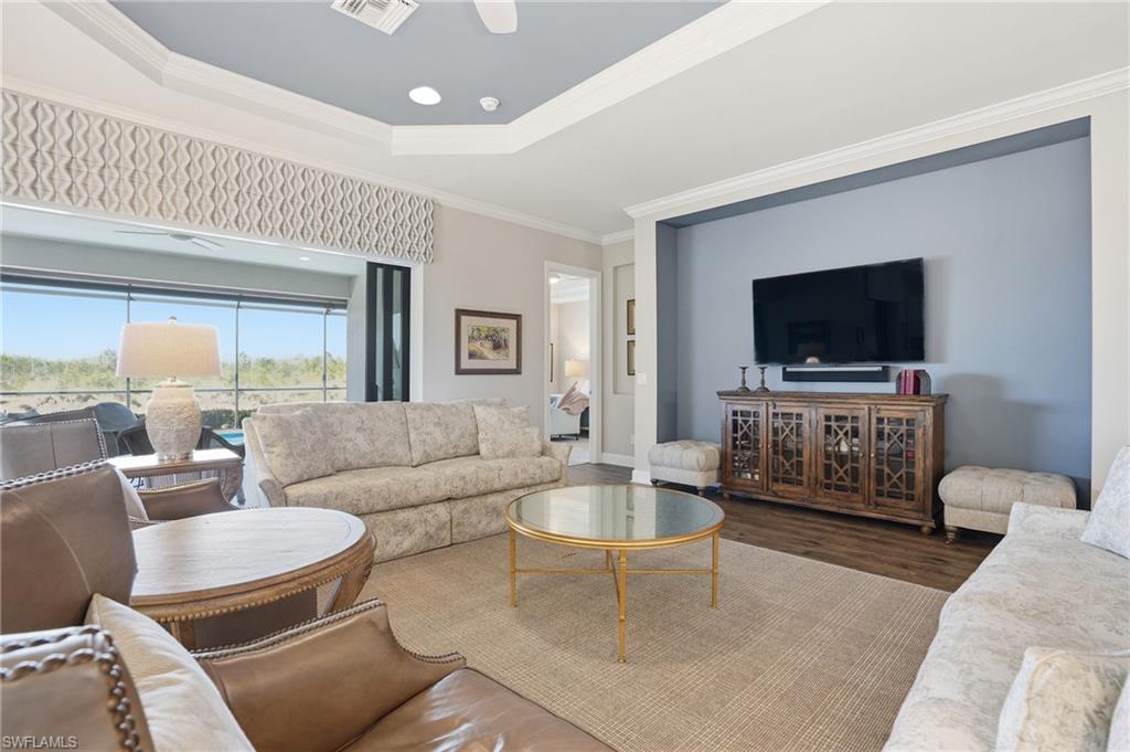 9489 Montelanico Loop Naples, FL 34119 - Photo 7 of 49 Living room featuring wood finished floors and crown molding