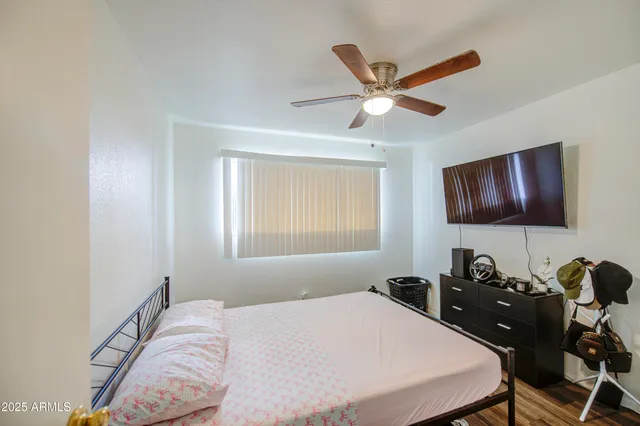 a bedroom that has a bed and a chandelier