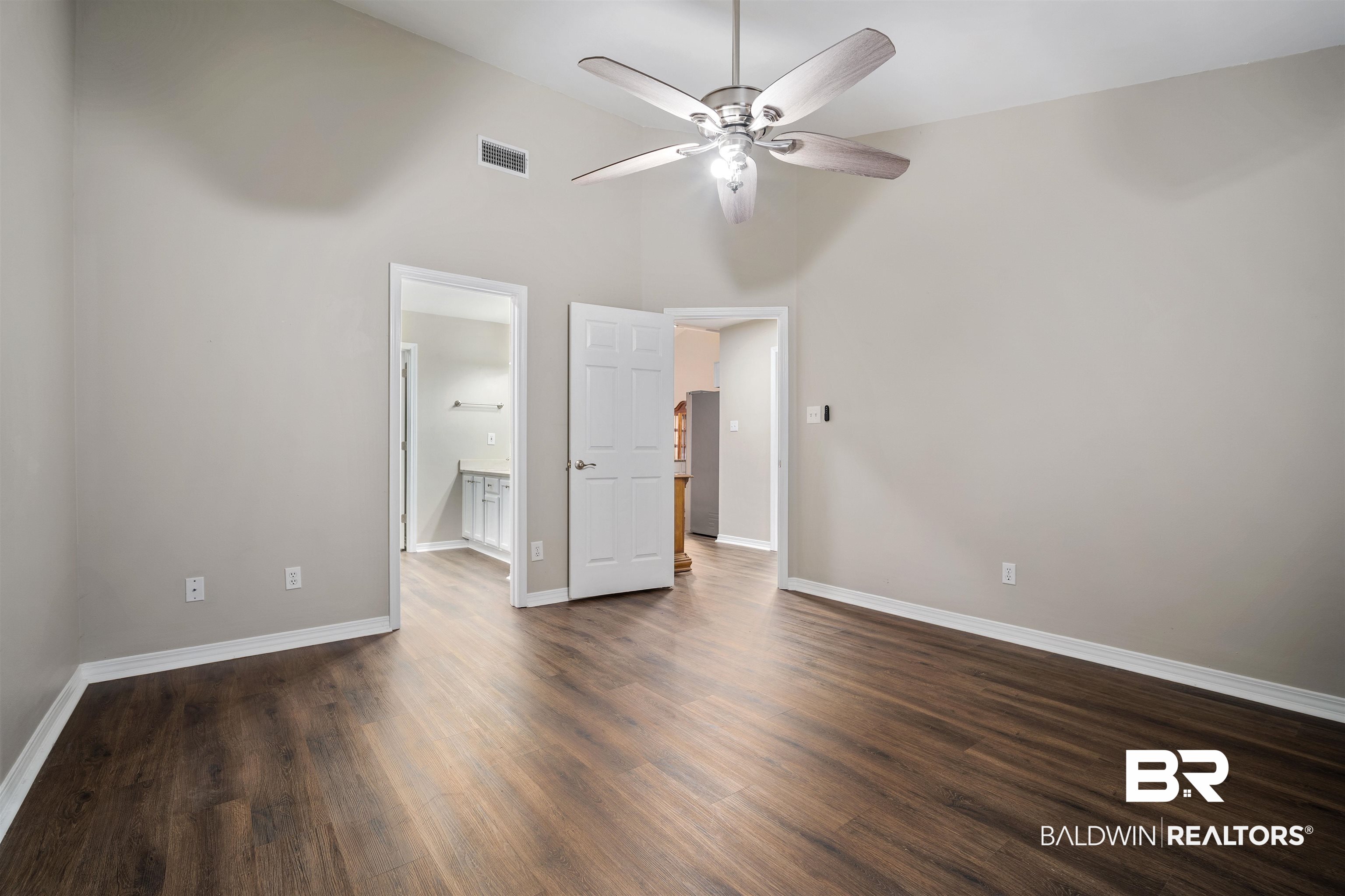 628 Spring Lake Court Mobile, AL 36695 - Photo 18 of 25 Unfurnished bedroom with ensuite bath, high vaulted ceiling, dark hardwood / wood-style floors, and ceiling fan
