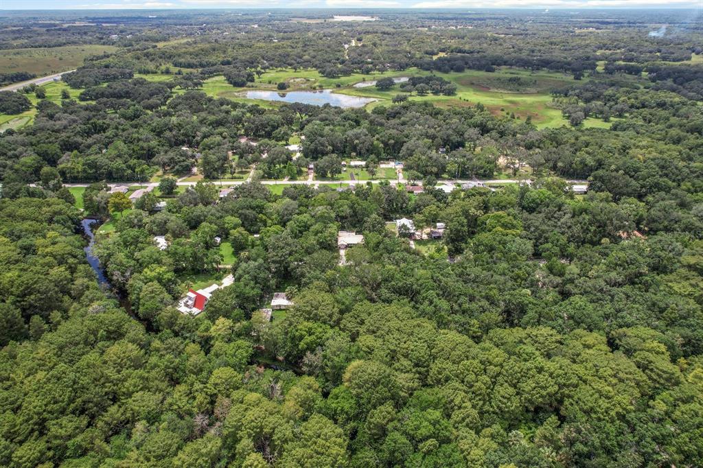 523 South Tuck Point Inverness, FL 34450 - Photo 2 of 28 an aerial view of residential houses with outdoor space and trees