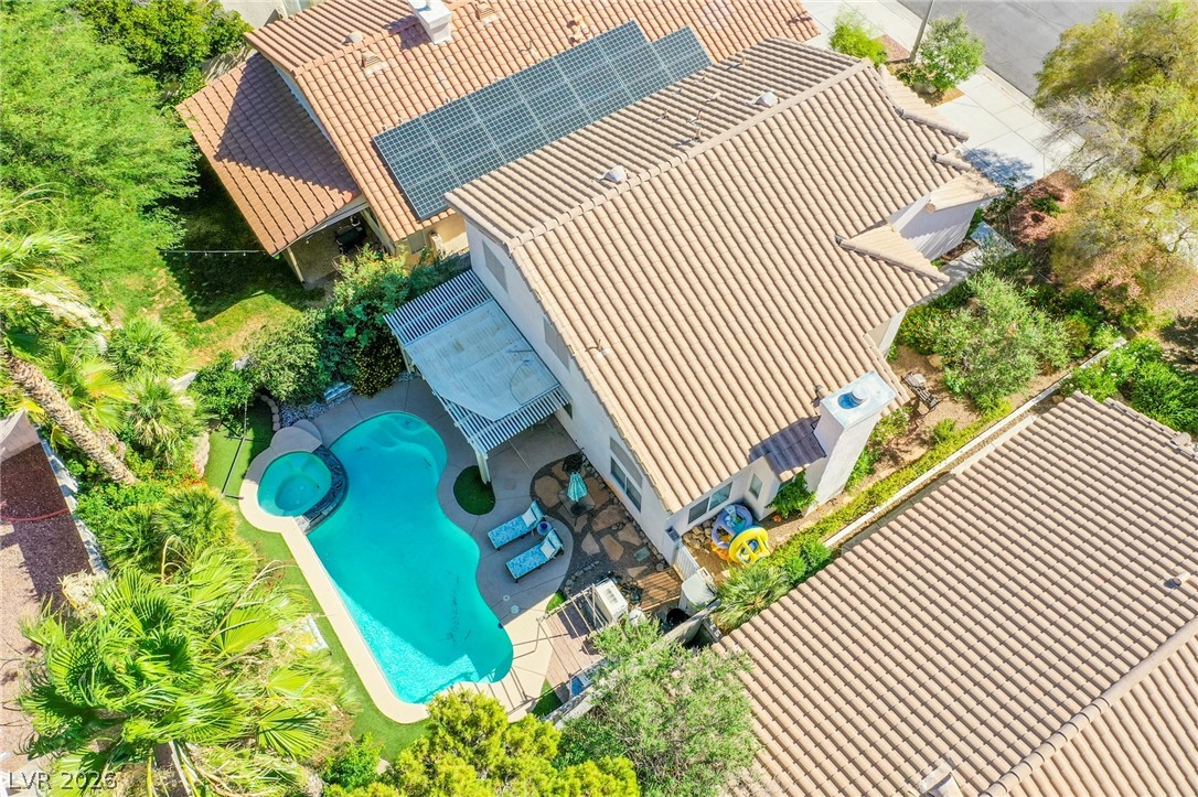 253 Camelback Ridge Avenue Henderson, NV 89012 - Photo 26 of 26 An aerial perspective showcases a private backyard pool and patio enclosed by lush desert landscaping.