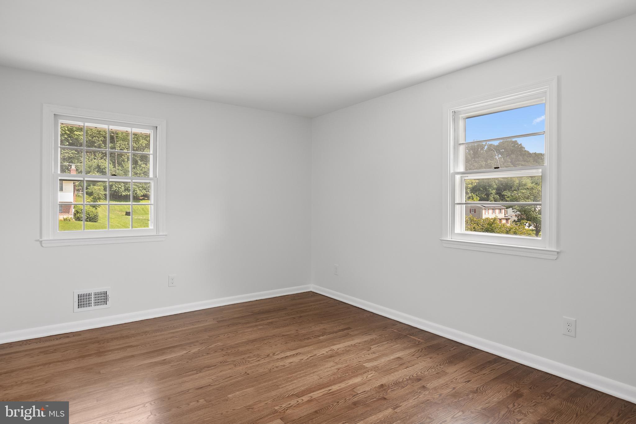 215 East Timonium Road Lutherville-Timonium, MD 21093 - Photo 23 of 33 a view of an empty room with wooden floor and a window