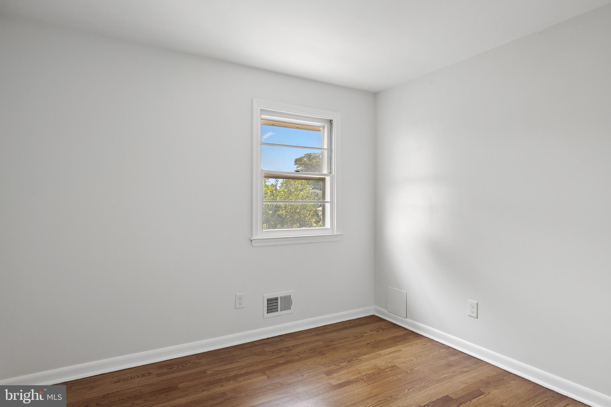 215 East Timonium Road Lutherville-Timonium, MD 21093 - Photo 24 of 33 an empty room with wooden floor and a window