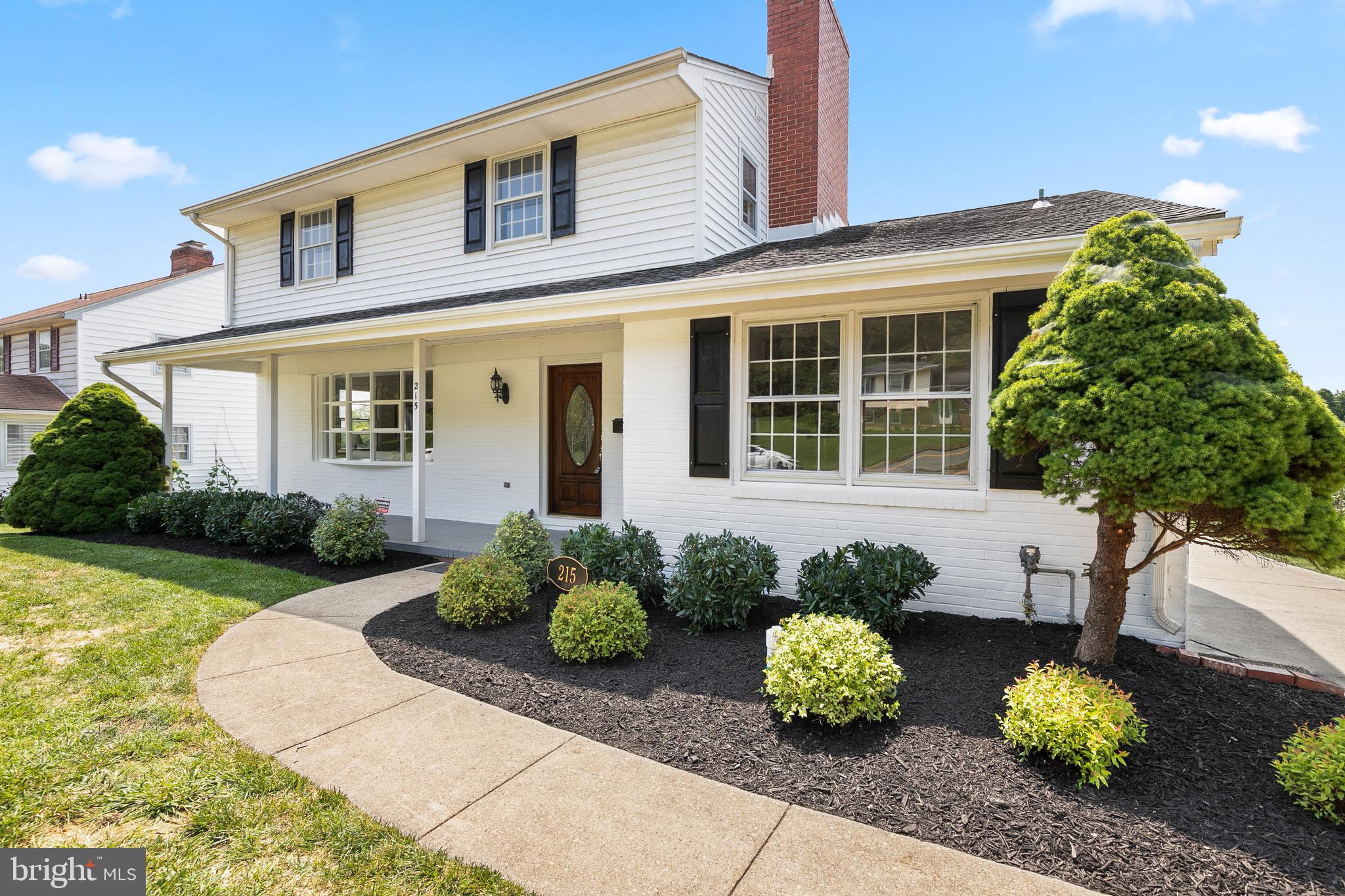 215 East Timonium Road Lutherville-Timonium, MD 21093 - Photo 3 of 33 a front view of a house with a yard