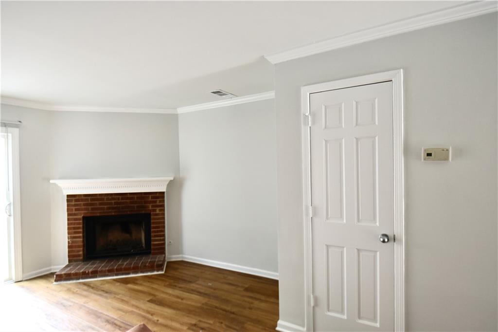 2898 Webb Bridge Road Alpharetta, GA 30009 - Photo 2 of 8 a view of a livingroom with an empty space and a fireplace