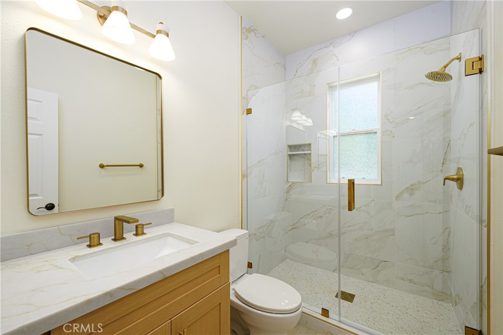 15 Plum Street Ladera Ranch, CA 92694 - Photo 37 of 113 a bathroom with a granite countertop sink a mirror and a shower