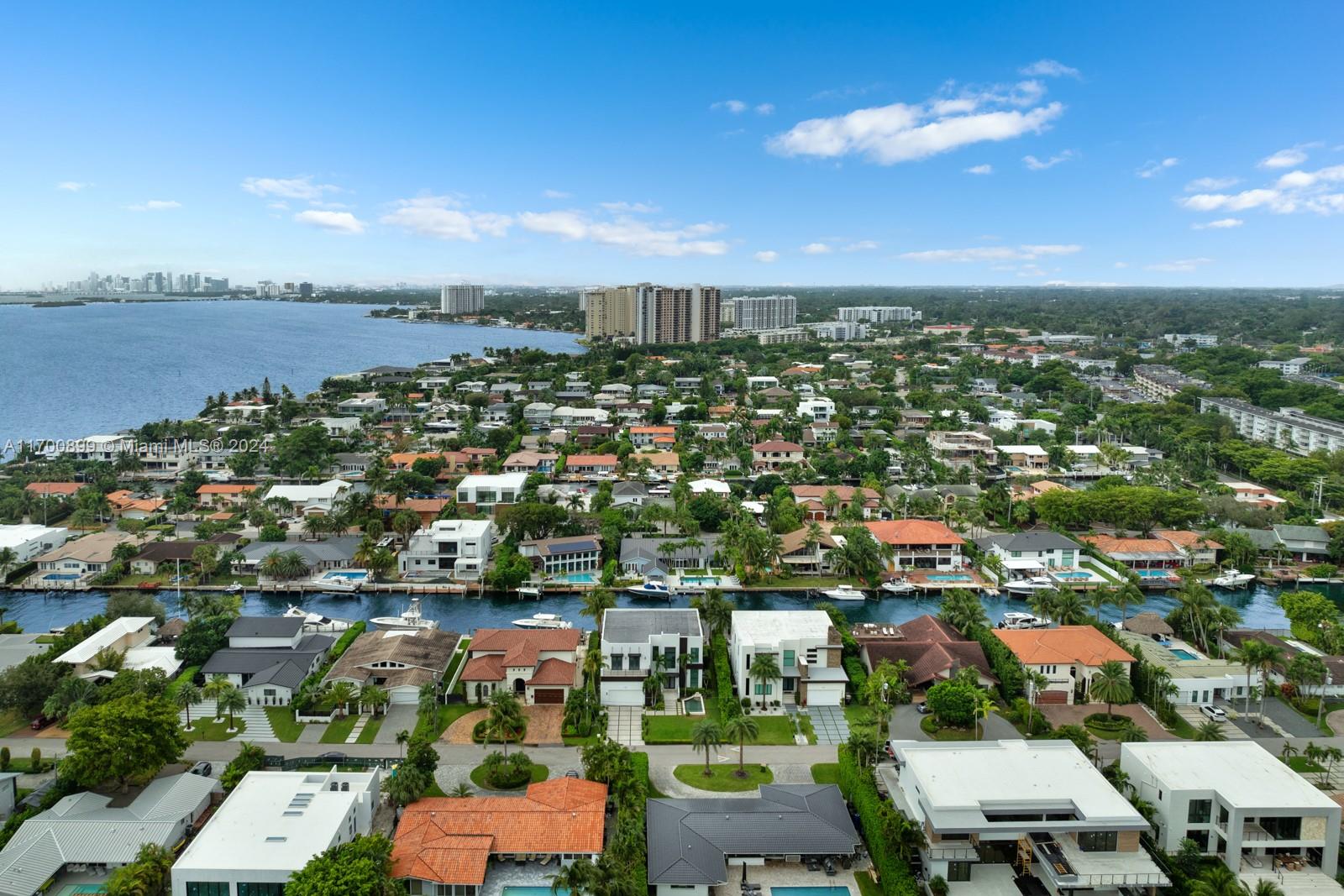 2040 Northeast 121st Road North Miami, FL 33181 - Photo 21 of 43 an aerial view of a city with lots of residential buildings ocean and mountain view in back