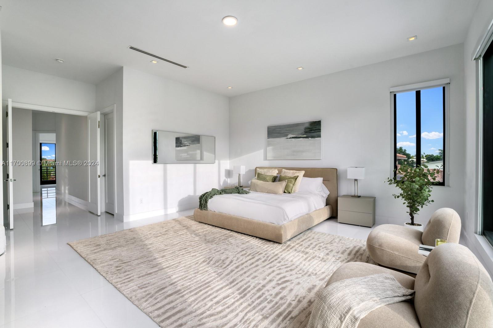 2040 Northeast 121st Road North Miami, FL 33181 - Photo 27 of 43 a bedroom with a large bed and a couch