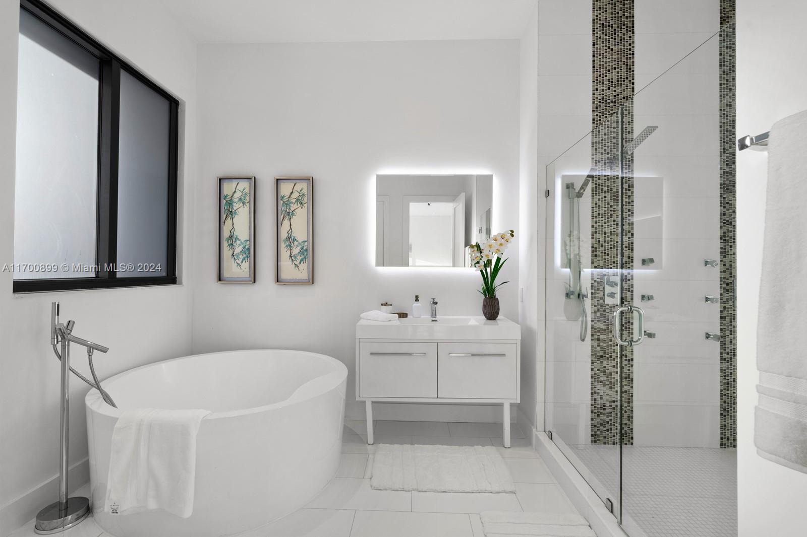 2040 Northeast 121st Road North Miami, FL 33181 - Photo 29 of 43 a bathroom with a bathtub a sink and a window